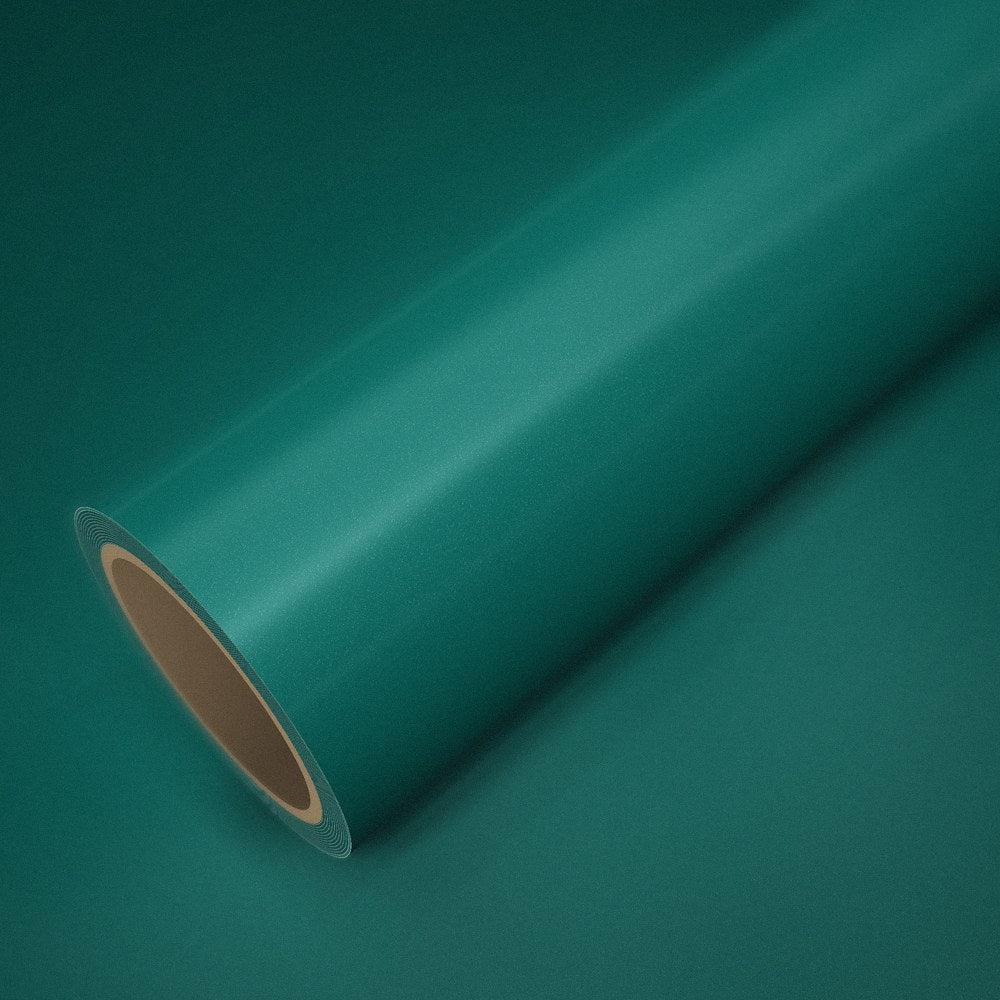 Roll of ICR® Aston green vinyl wrap on a sheet of the same vinyl