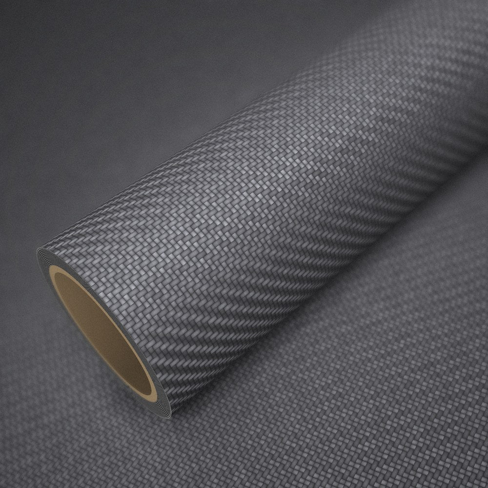 Roll of anthracite carbon vinyl wrap on a sheet of the same vinyl