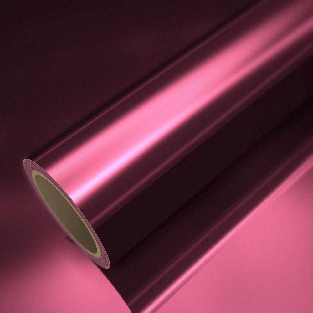 Roll of reddish pink chrome vinyl wrap on a sheet of the same vinyl