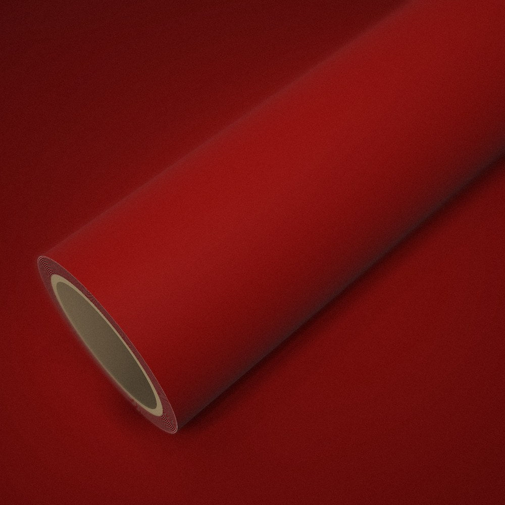 Roll of matte red vinyl wrap on a sheet of the same vinyl