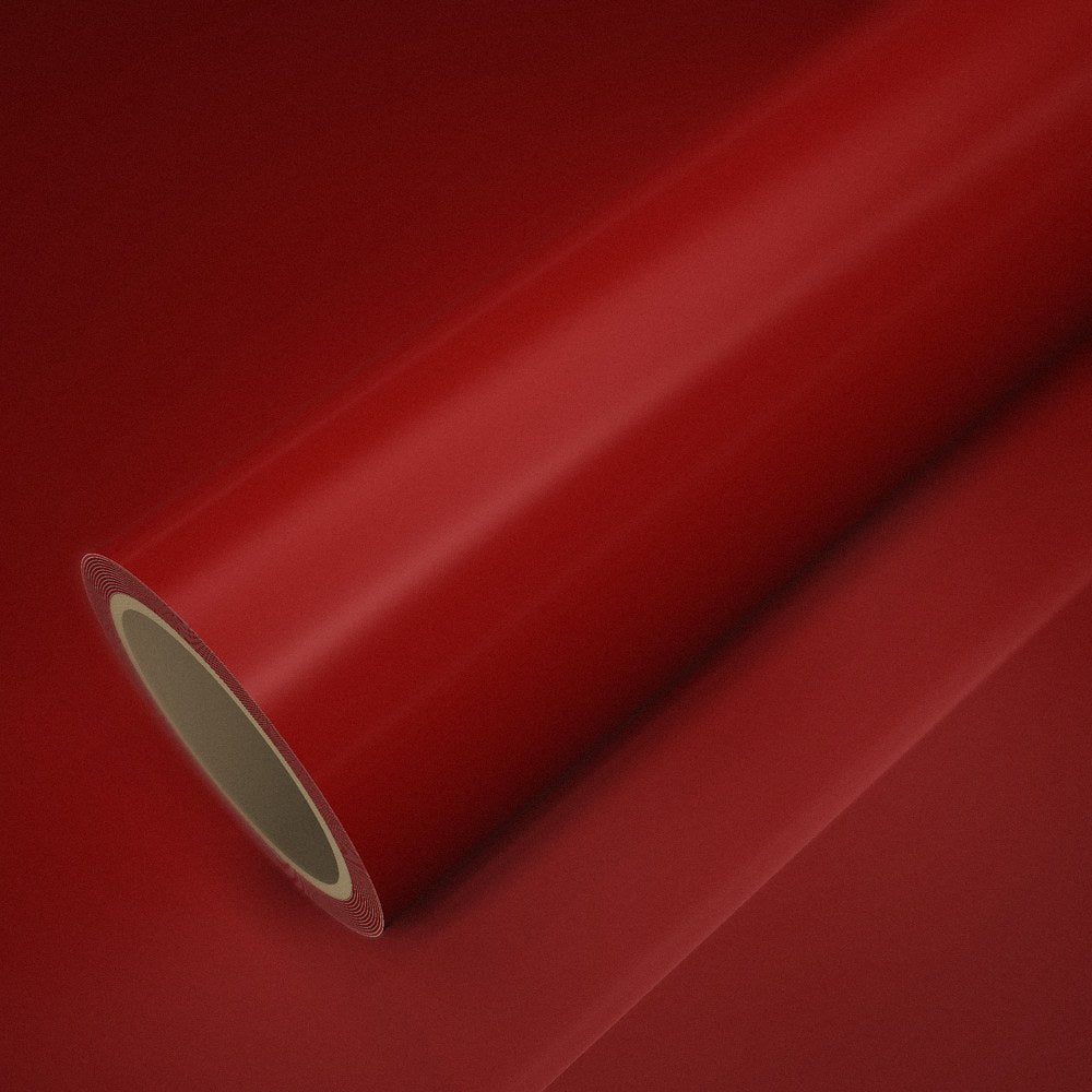 Roll of gloss red vinyl wrap on a sheet of the same vinyl