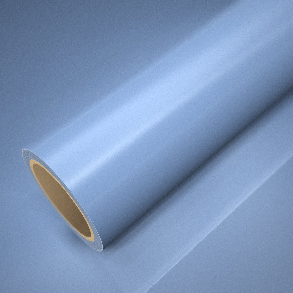 Roll of ICR® extra gloss mist blue vinyl wrap on a sheet of the same vinyl