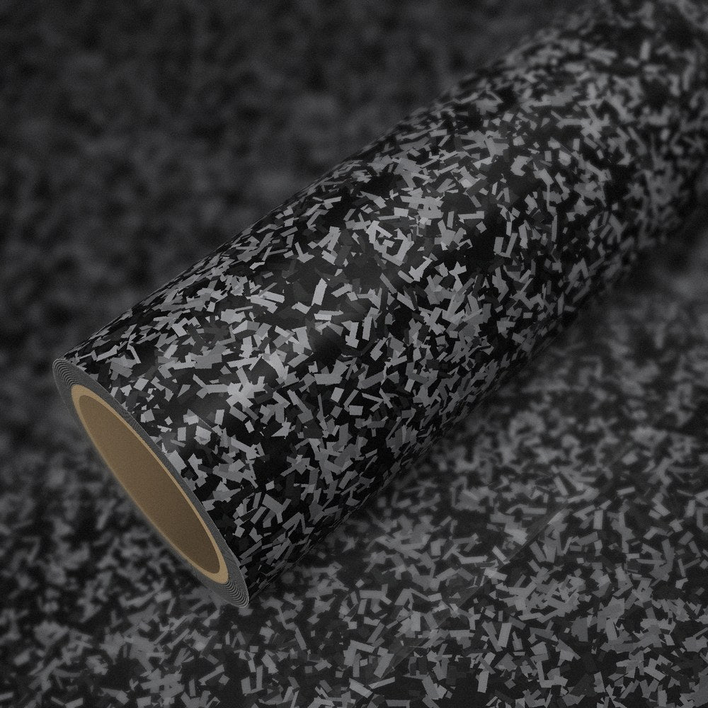 Roll of gloss silver forged carbon vinyl wrap on a sheet of the same vinyl