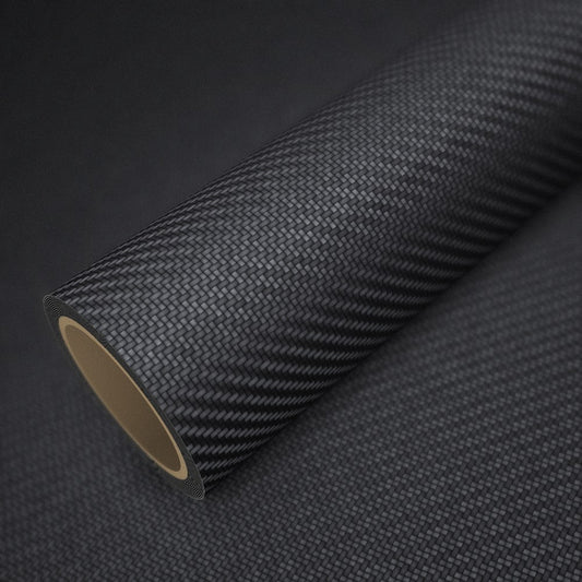 Roll of matte black carbon vinyl wrap on a sheet of the same vinyl