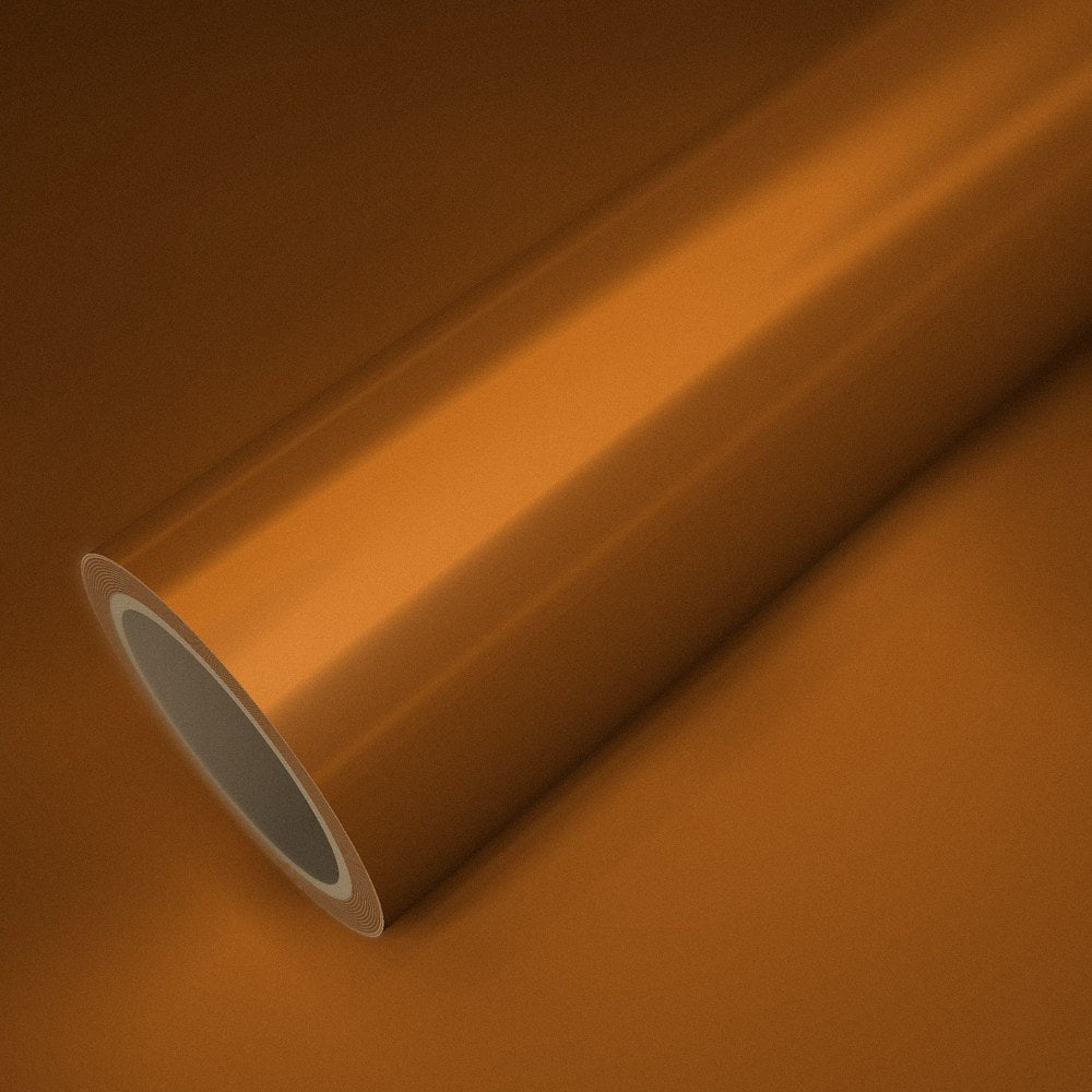 Roll of matte chrome orange vinyl wrap on a sheet of the same vinyl