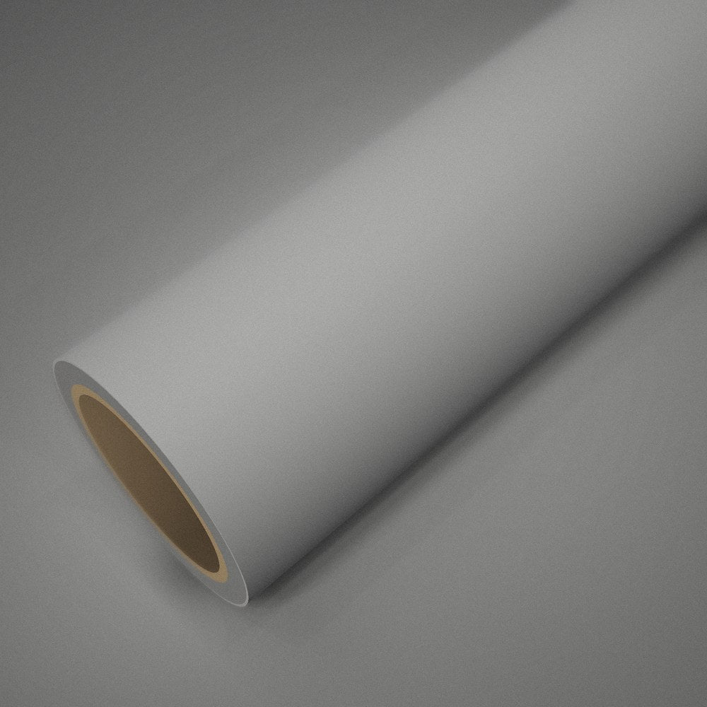 Roll of matte white vinyl wrap on a sheet of the same vinyl