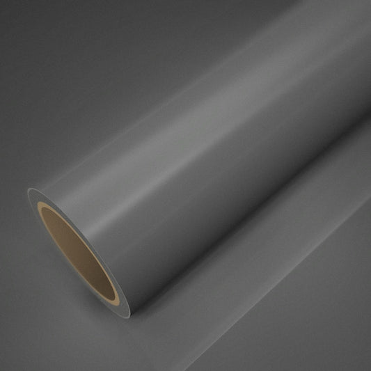 Roll of gloss cement grey vinyl wrap on a sheet of the same vinyl