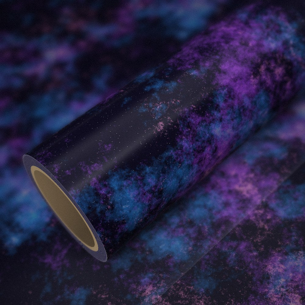 Roll of galaxy vinyl wrap on a sheet of the same vinyl